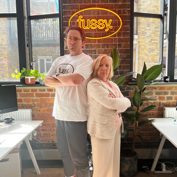 Das Fussy-Team vor dem gelben Neonschriftzug